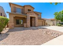 Two-story home with stone accents and a landscaped yard at 16109 W Christy Dr, Surprise, AZ 85379