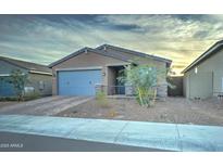 Single-story home with a two-car garage and landscaped front yard at 19945 W Badgett Ln, Litchfield Park, AZ 85340
