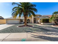 Single story home with desert landscaping and a large driveway at 21214 N 124Th Ave, Sun City West, AZ 85375