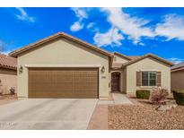 Charming single-story home with a two-car garage, desert landscaping, and a welcoming entrance at 6546 W Georgetown Way, Florence, AZ 85132