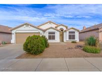 One-story home with tan colored garage and landscaping at 1024 E Blackhawk Dr, Phoenix, AZ 85024