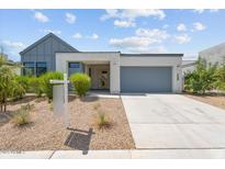 Contemporary home with desert landscaping, gray garage door, and light-colored facade at 1113 E La Mirada Dr, Phoenix, AZ 85042