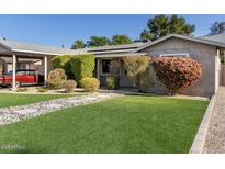 House exterior with carport, landscaped lawn, and stone pathway at 3323 N 28Th St, Phoenix, AZ 85016