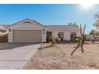 Single-story home with a two-car garage and well-maintained landscaping at 9041 W Virginia Ave, Phoenix, AZ 85037