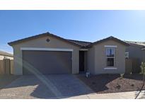 Charming single-story home with a two-car garage and desert landscaping at 17659 W Bajada Rd, Surprise, AZ 85387