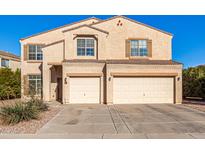 Two-story house with beige exterior, two-car garage, and landscaping at 35834 W Cartegna Ln, Maricopa, AZ 85138