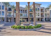 Eight Biltmore Estates building exterior, featuring palm trees and a circular driveway at 8 E Biltmore Est # 117, Phoenix, AZ 85016