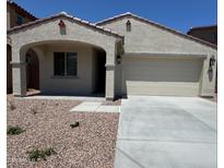 Charming single-story home with a two-car garage, low-maintenance landscaping and covered entry at 16768 W Hope Dr, Surprise, AZ 85388
