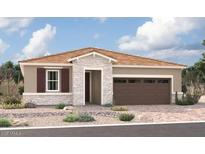 One-story home with brown roof, stone accents, and a two-car garage at 5024 W Roundhouse Rd, Laveen, AZ 85339