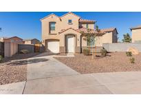 Two-story house with tan exterior, tile roof, and a landscaped front yard at 5234 W Odeum Ln, Phoenix, AZ 85043