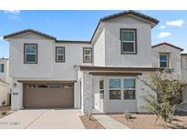 Two-story home with light-colored exterior and landscaped yard at 570 W Copper Way, Chandler, AZ 85225