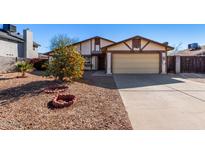 Single story home with attached garage and landscaped front yard at 7517 W Desert Cove Ave, Peoria, AZ 85345