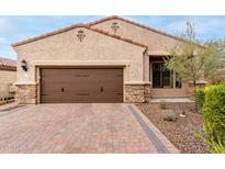 Single-story home with brown garage door and brick paver driveway at 1756 N Makalu Cir, Mesa, AZ 85207