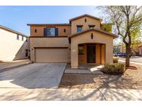 Inviting two-story home features a covered porch and attached two-car garage at 18409 W Dawn Dr, Surprise, AZ 85374
