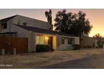 Inviting single-story home with a well-maintained front yard at sunset at 2221 W Farmdale Ave # 17, Mesa, AZ 85202