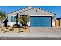 Single-story home with a blue garage door and landscaped front yard at 22432 W Kimberly Dr, Buckeye, AZ 85326
