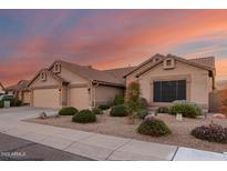 Tan two-story house with three-car garage, landscaping, and desert plants at 28840 N 46Th St, Cave Creek, AZ 85331