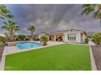 Luxury home with a spacious backyard, pool, and lush landscaping at 32159 N 127Th Dr, Peoria, AZ 85383