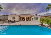 Beautiful home with a large patio, pool, and spacious backyard at 32159 N 127Th Dr, Peoria, AZ 85383