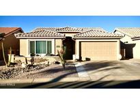 Tan one-story house with a two-car garage and landscaped front yard at 6740 S Coral Gable Dr, Chandler, AZ 85249