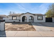 Newly renovated single story home with a modern facade and a spacious front yard at 6807 W Colter St, Glendale, AZ 85303