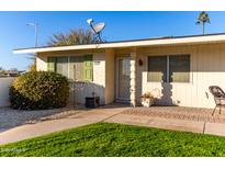 Inviting single-story home with well-manicured lawn and attractive landscaping at 9255 N 111Th Ave, Sun City, AZ 85351