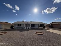 Ranch style home with gravel yard and carport at 10607 W Sun City Blvd, Sun City, AZ 85351