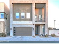 Modern two-story home with attached garage and balcony at 1553 N 69Th Pl, Scottsdale, AZ 85257