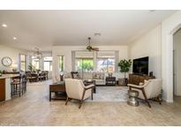 Spacious living room with tile floors and views of backyard at 17824 W Addie Ln, Surprise, AZ 85374