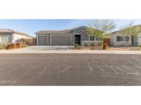 Single-story house with a two-car garage and well-maintained landscaping at 2476 N Abbey Rd, Casa Grande, AZ 85122