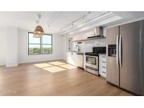 Modern kitchen with stainless steel appliances and white cabinetry at 535 W Thomas Rd # 508, Phoenix, AZ 85013