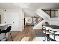 Open concept dining area with hardwood floors and modern table at 8375 E Indian School Rd, Scottsdale, AZ 85251