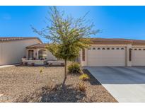Single-story home with two-car garage and desert landscaping at 10960 E Monte Ave # 125, Mesa, AZ 85209