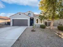 Two-story house with a two-car garage and desert landscaping at 37855 W Merced St, Maricopa, AZ 85138