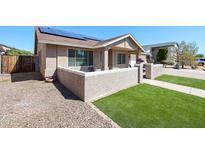 Charming single-story home featuring a well-maintained landscape, stucco walls, and solar panels for energy efficiency at 6352 W Campo Bello Dr, Glendale, AZ 85308
