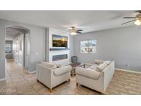 Bright living room with fireplace and comfortable seating at 13257 W Avenida Del Rey Dr, Peoria, AZ 85383