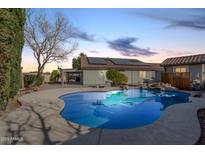 Inviting kidney-shaped pool with surrounding rock landscaping at 16294 N 159Th Dr, Surprise, AZ 85374