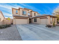Two-story house with three-car garage, desert landscaping, and light-colored exterior at 18147 W Desert View Ln, Goodyear, AZ 85338