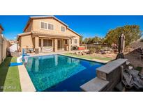 Inviting backyard oasis featuring a sparkling pool, spa, and ample patio space at 25543 W St Kateri Dr, Buckeye, AZ 85326