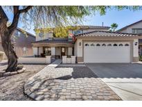 Two-story house with tile roof, large windows, and a paved driveway at 3215 W Molly Ln, Phoenix, AZ 85083