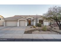 Single-story home with a two-car garage and desert landscaping at 5037 E Sleepy Ranch Rd, Cave Creek, AZ 85331