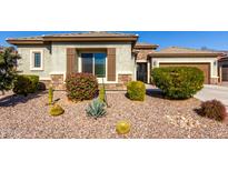 One-story home with desert landscaping and a two-car garage at 5640 W Victory Way, Florence, AZ 85132