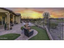 Covered patio, firepit, and artificial turf at 12128 W Desert Mirage Dr, Peoria, AZ 85383