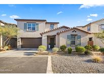 Two-story home with brown garage door and landscaping at 17755 W Jojoba Rd, Goodyear, AZ 85338