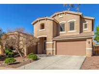 Two-story house with tan exterior, attached garage, and landscaping at 2614 W Florimond Rd, Phoenix, AZ 85086