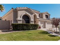 Two-story house with a three-car garage and manicured lawn at 3331 S Vine St, Chandler, AZ 85248