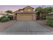 Two-story house with a tan exterior, two-car garage, and landscaped front yard at 343 W Bolero Dr, Tempe, AZ 85284