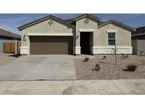 Charming single-story home with a two-car garage and neutral stucco exterior with decorative accents at 38130 W Bello Ln, Maricopa, AZ 85138