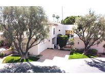 Stunning white two-story home with well-manicured front lawn and mature trees at 10113 E Topaz Dr, Scottsdale, AZ 85258