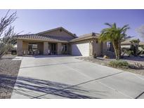 Tan one-story house with desert landscaping and a two-car garage at 147 S Los Cielos Ln, Casa Grande, AZ 85194